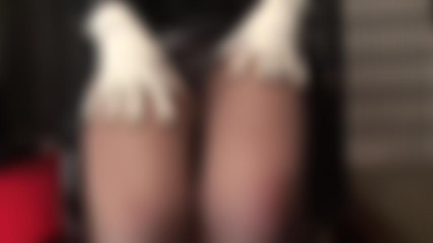 Black and white tease - Pretty white ankle strap heels, white gloves and white bodysuit are in contrast to the shiny black pvc. Mistress teases with upskirt views and coffee brown pantyhose legs.