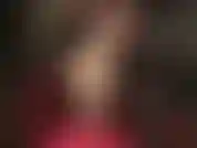 Showing off long legs in nude pantyhose and red steel heel pumps.