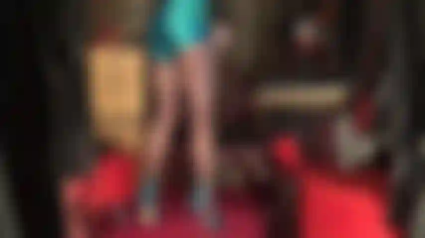 Admire mistress' long and strong legs in sheer coffee brown pantyhose that lead up to an extremely shiny pair of blue satin shorts.