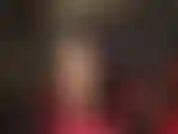 Sexy nude pantyhose leg tease, black hair, black leather, red bodysuit and red ankle strap stilettos.