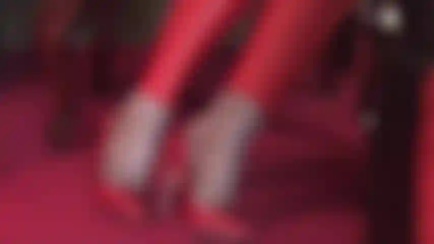 Pantyhose foot tease in red leather pumps and matching leggings.