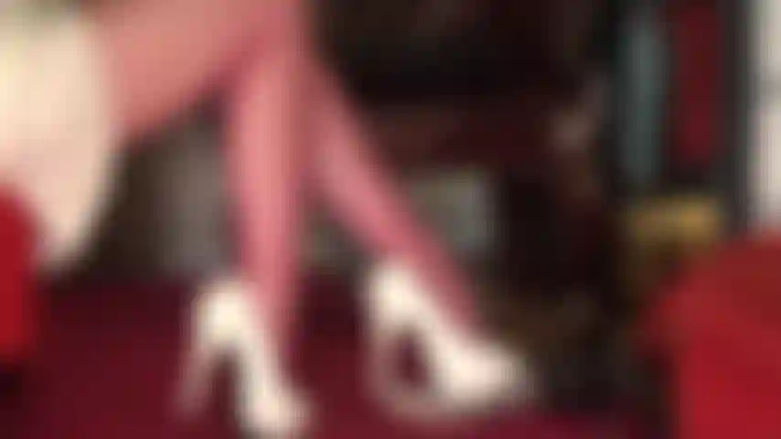 Beautiful thighs and legs in red pantyhose with upskirt views in pretty satin skirt.