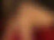 Sexy crossed nude nylon leg tease in red shiny pumps.