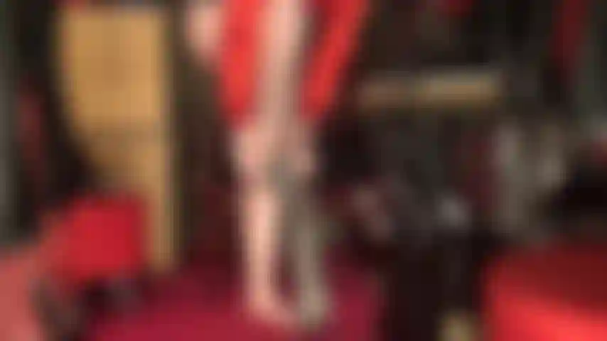 Mistress slides on shiny gray pantyhose and black pumps to tease the leg lover with.