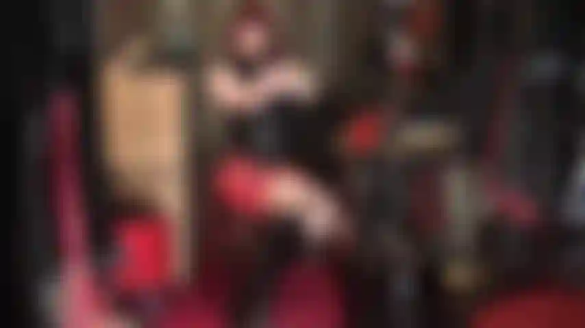 Latex fetish - red and black rubber outfit with knee boots.