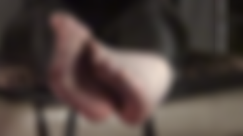 Foot fetish - teasing feet are twirling in off-black sheer pantyhose.