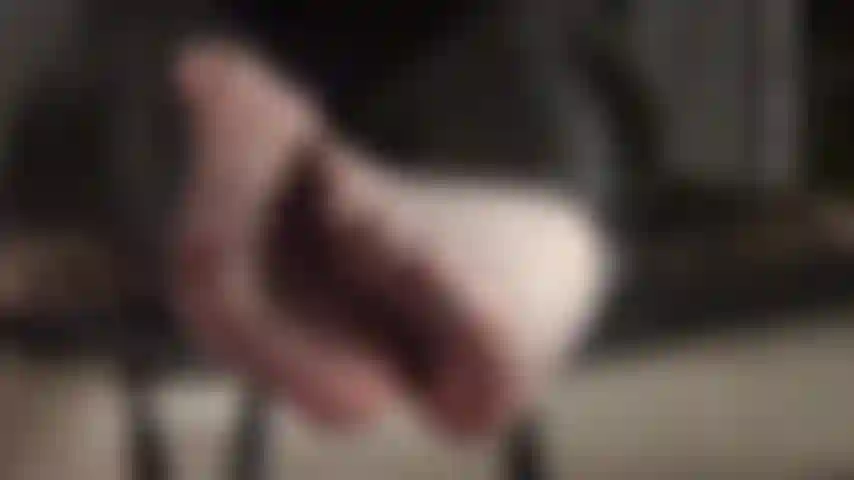 Foot fetish - teasing feet are twirling in off-black sheer pantyhose.