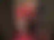 Mistress vivian, dressed in red hot glossy latex, bare legs, high heels, long shiny gloves.