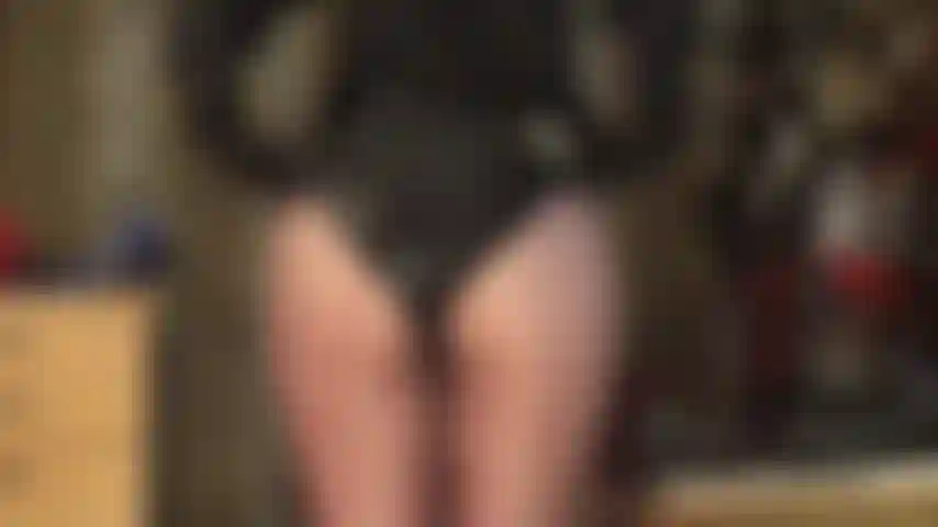 Mistress teases with her famous round ass in shiny shorts and glossy brown pantyhose.