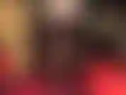 Crossed legs fetish in opaque dark brown tights and steel heel pumps.