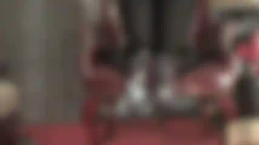 Mistress kicks off her heels, sheer pantyhose feet dangling off the chair.