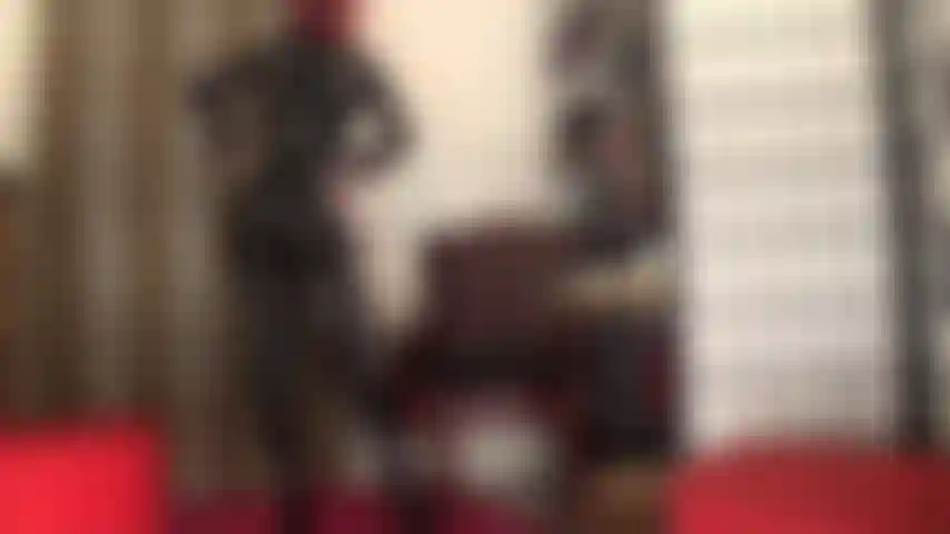 Goddess worship in tight black pvc catsuit, corset and thigh length boots.