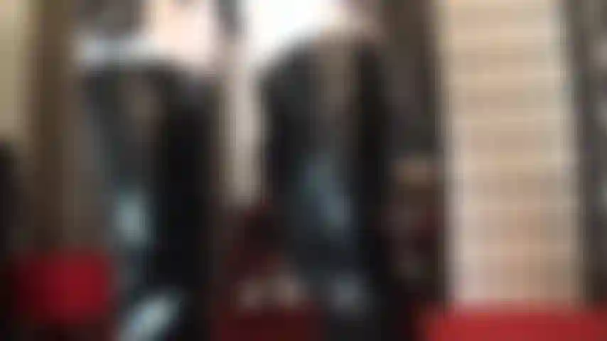 Black and white outfit of shiny pvc fetish boots and gloves paired with white glossy lycra tights.