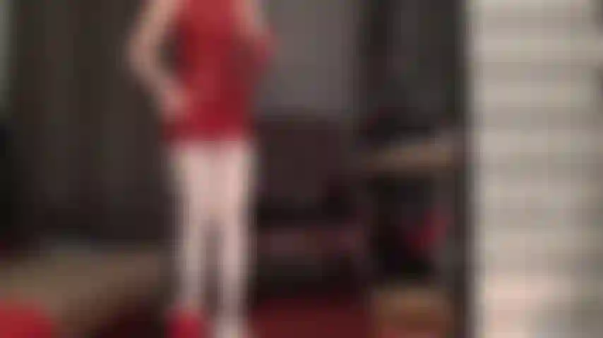 Red latex pairs well with white pantyhose - mistress wears a skimpy red rubber mini dress and glossy white pantyhose. She adds shoulder length latex gloves and a tiny red thong for temping upskirt views.