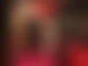 Sensual tease and body worship in red and black - mistress wears a sexy dress with leather corset, nude shiny pantyhose and glossy red pumps.