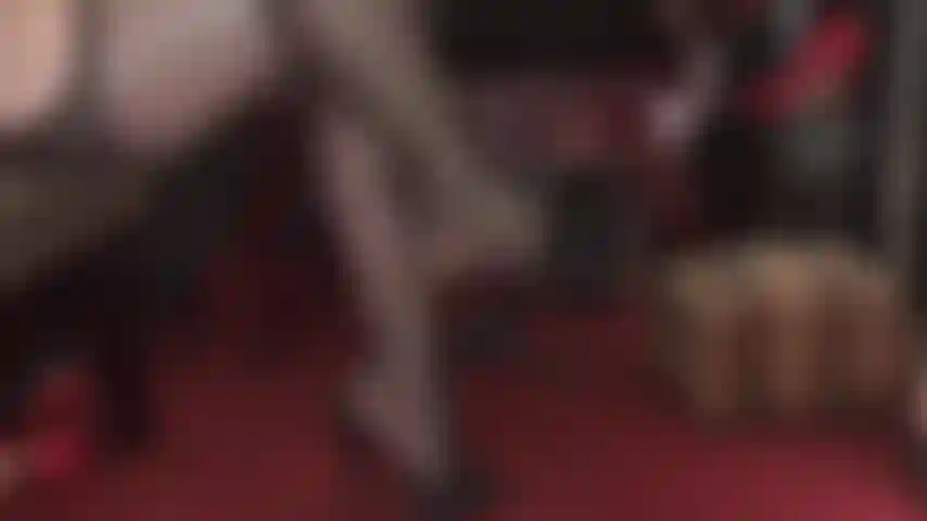 Worship mistress' high heeled black leather mules, shapely feet and legs in garter pantyhose.