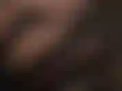 Face closeup, red glossy lipstick, black satin gloves.