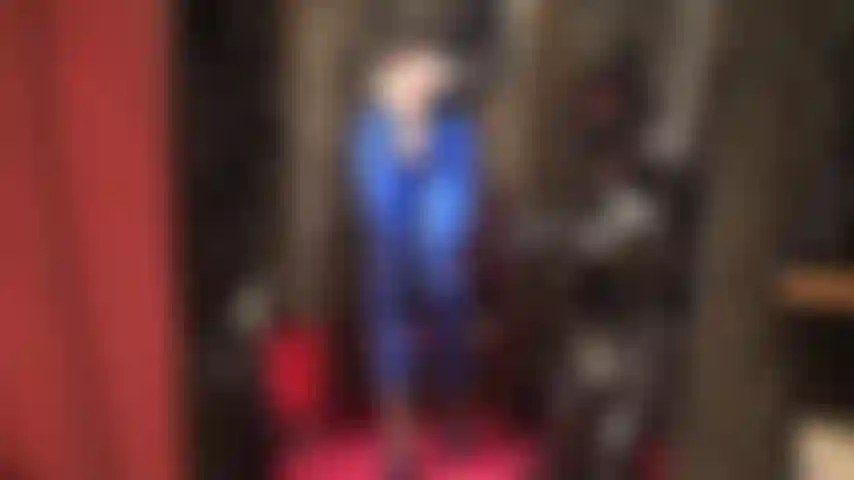 Hot blue metallic leggings and heels with big white stryker strap-on dildo.