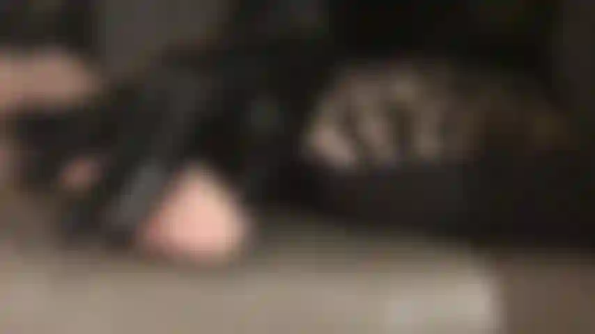 Exploiting your weakness for shiny black latex gloves - mistress gently teases your erect cock with her sleek latex fingers and thighs in glossy pantyhose and leather overknees boots.