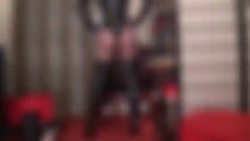 Shiny curves of perfection - shiny seductress displays her curves of perfection in thong pvc bodysuit, tall overknees boots and sheer black pantyhose.