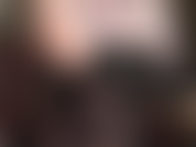 Sensual erotic tease with bare shoulders, armpits and cleavage in black leather corset, legs and black semi-opaque pantyhose.