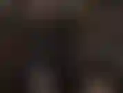 Black latex catsuit, white strapon and pantyhose mask.