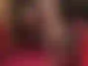 Sexy short dangling tease with shiny patent pumps and black stockings layered over nude pantyhose.