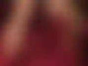 Closeup of hot red leather pumps dangling and shoe play.