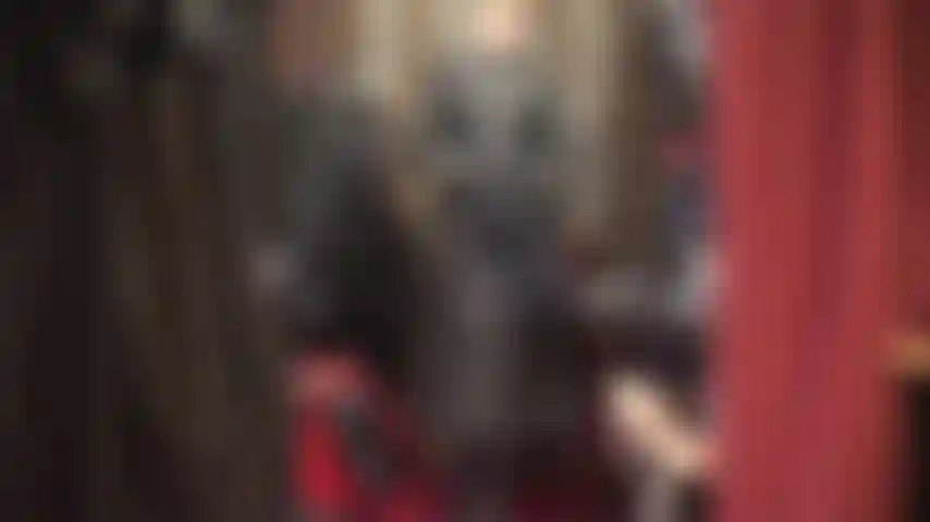 Worship mistress in a beautiful long leather coat, tall boots, and gloves.