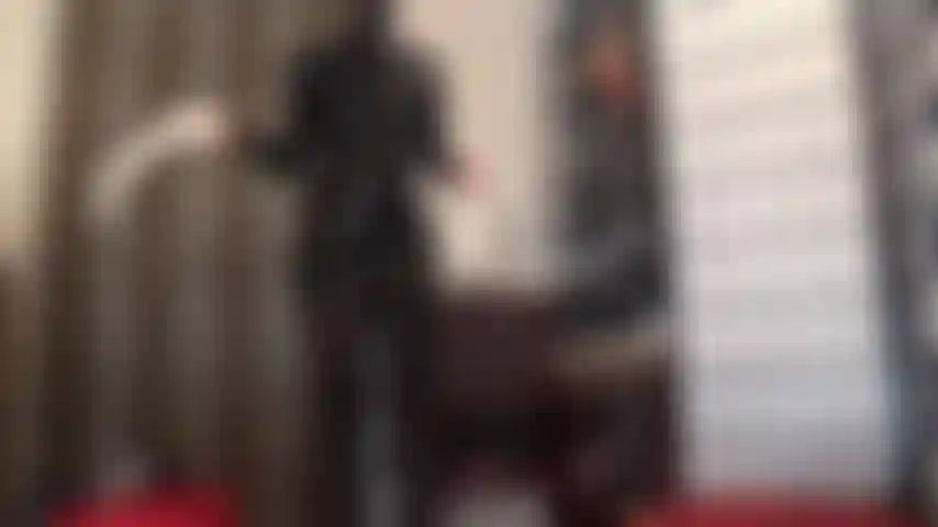 Latex rubber fetish - mistress dressed in black latex dress and rubber hood adds a pair of white latex gloves for an intensive cock milking.