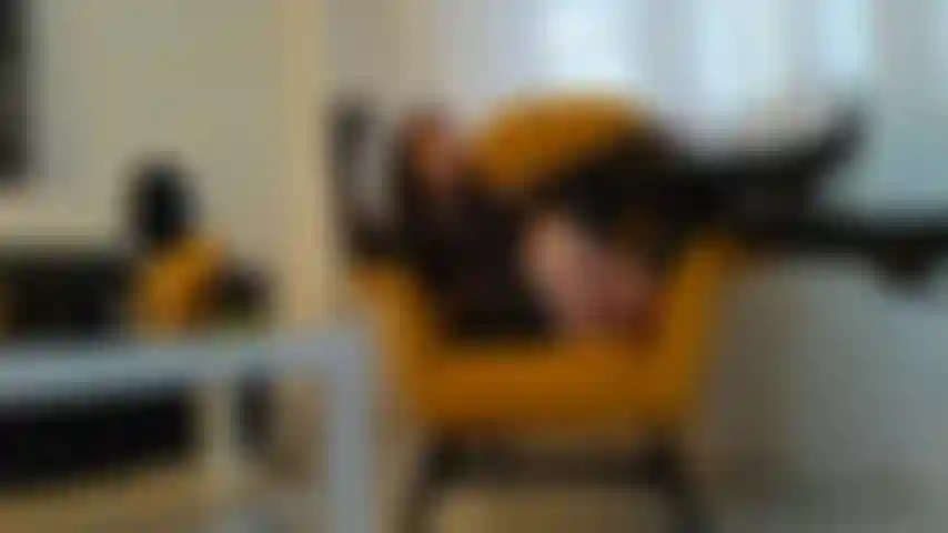 Smoking a cigar in leather gloves, boots & mini-skirt