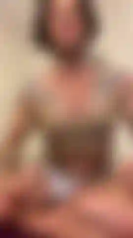 Posing muscles in tan top.