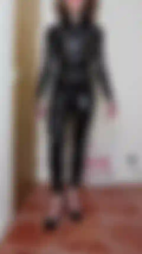 Latex catsuit strapon version 1 - Domme Mistress puts her strap-on over her latex catsuit