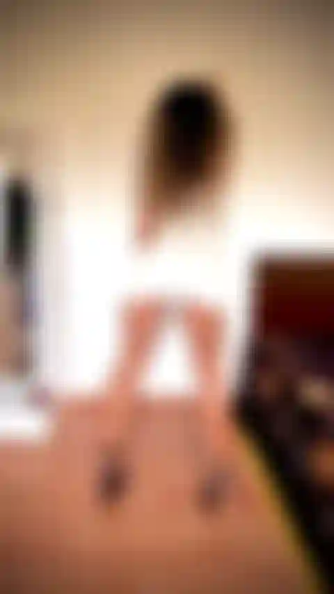 Amazing calves  & hamstrings flexing wearing tight short white dress, bending on the wall, no panties