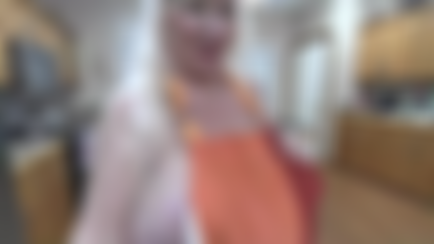 In_the_kitchen_in_apron,_ice_on_nipples,_bending_over.