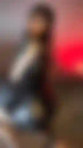 Sexy tattooed babe in black leather dress, fishnets, and spanking her ass.